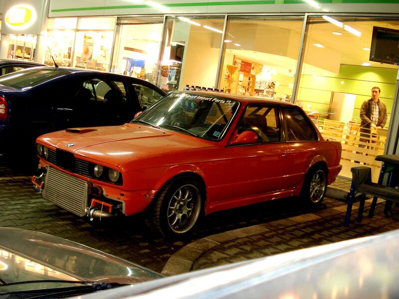 Red BMW in front of store