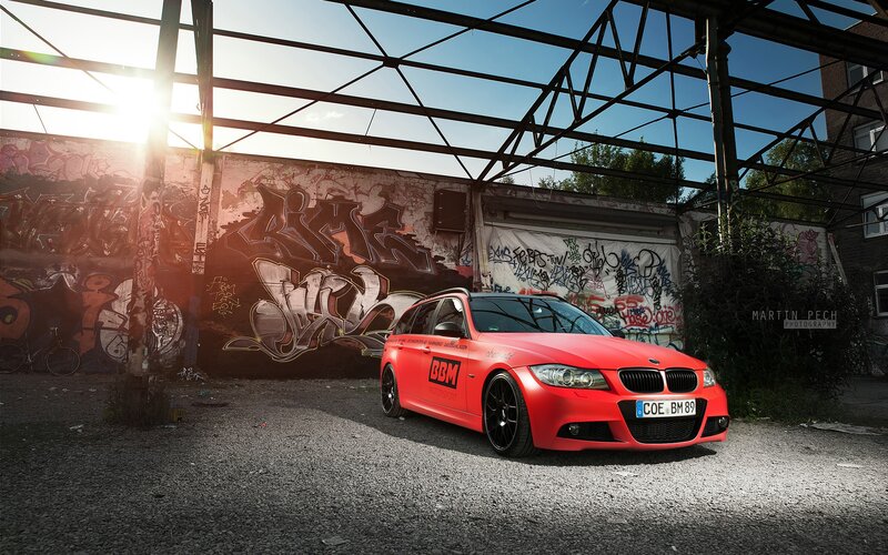 Red BMW in graffiti alley