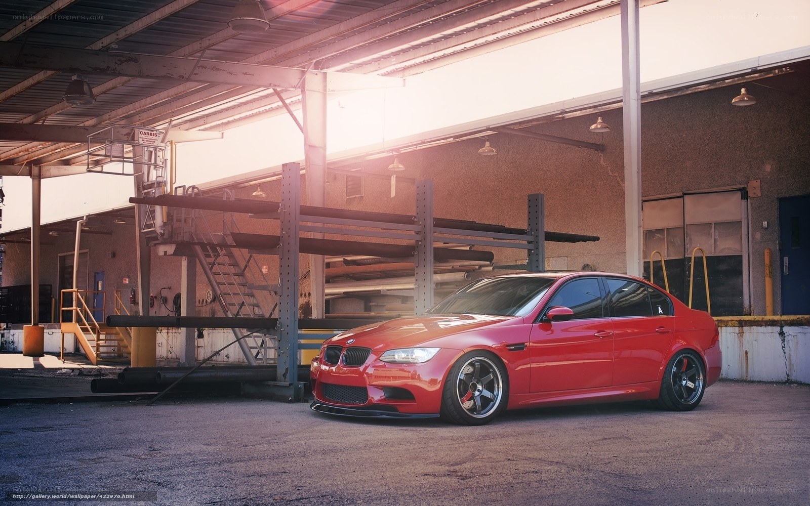 Red BMW in industrial lot
