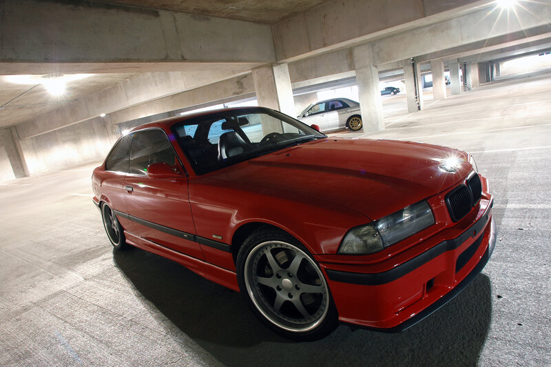 Red BMW in parking garage