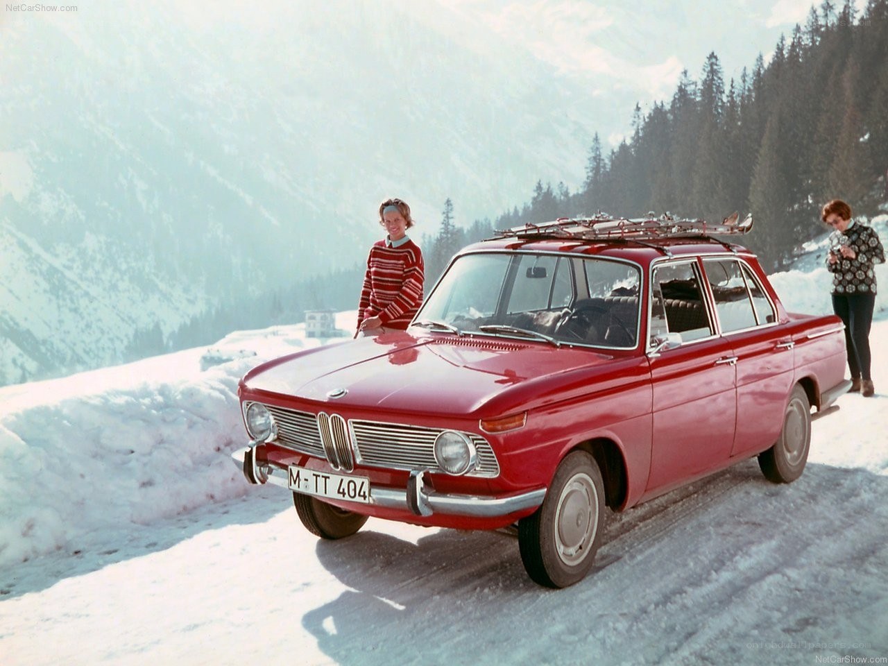 Red BMW in snowy mountains