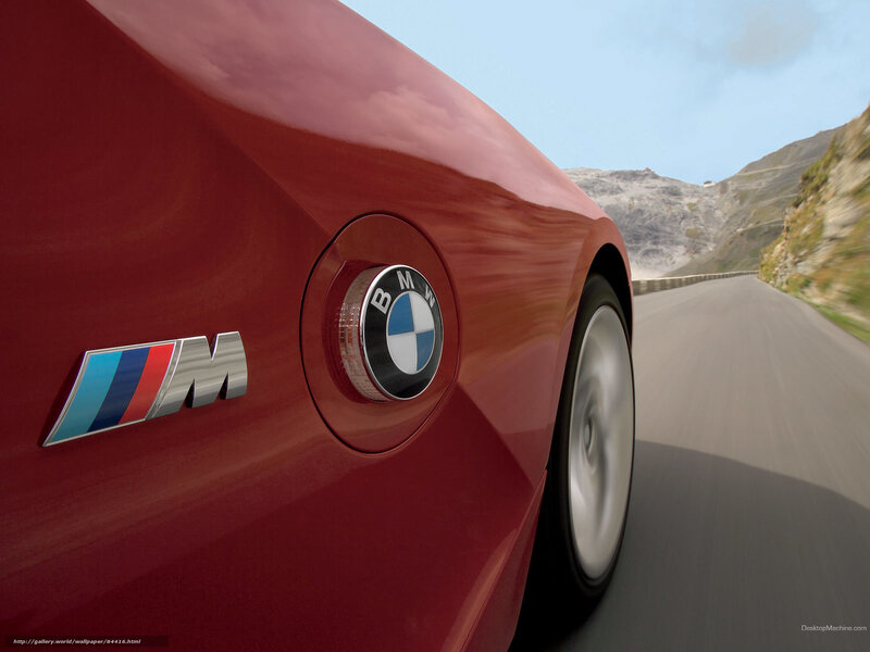 Red BMW M car on mountain road