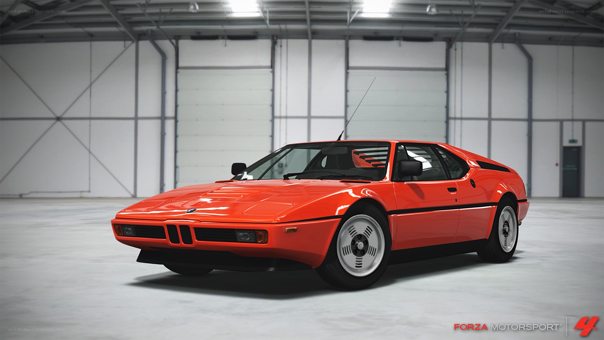 Red BMW M1 in a warehouse