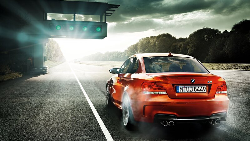 Red BMW M1 on a racetrack