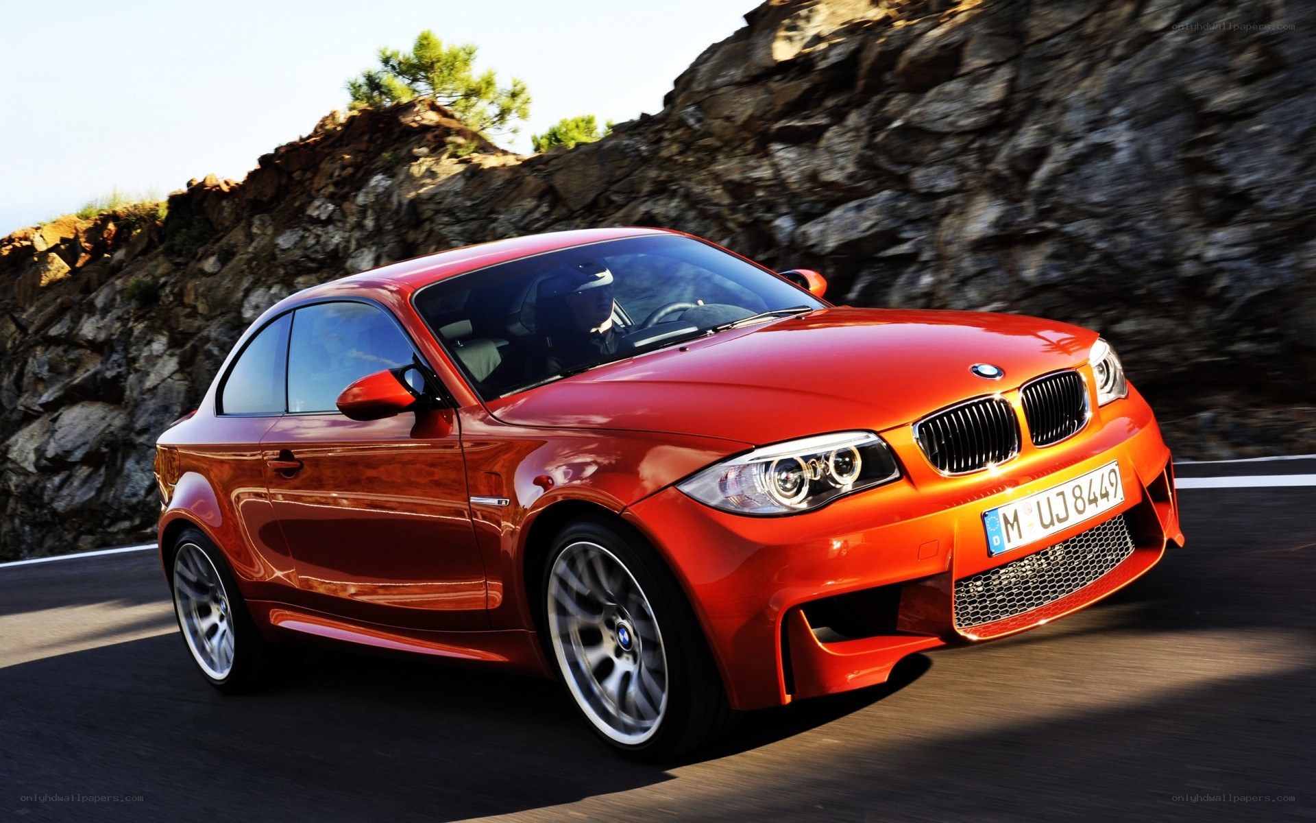 Red BMW M135i on a mountain road