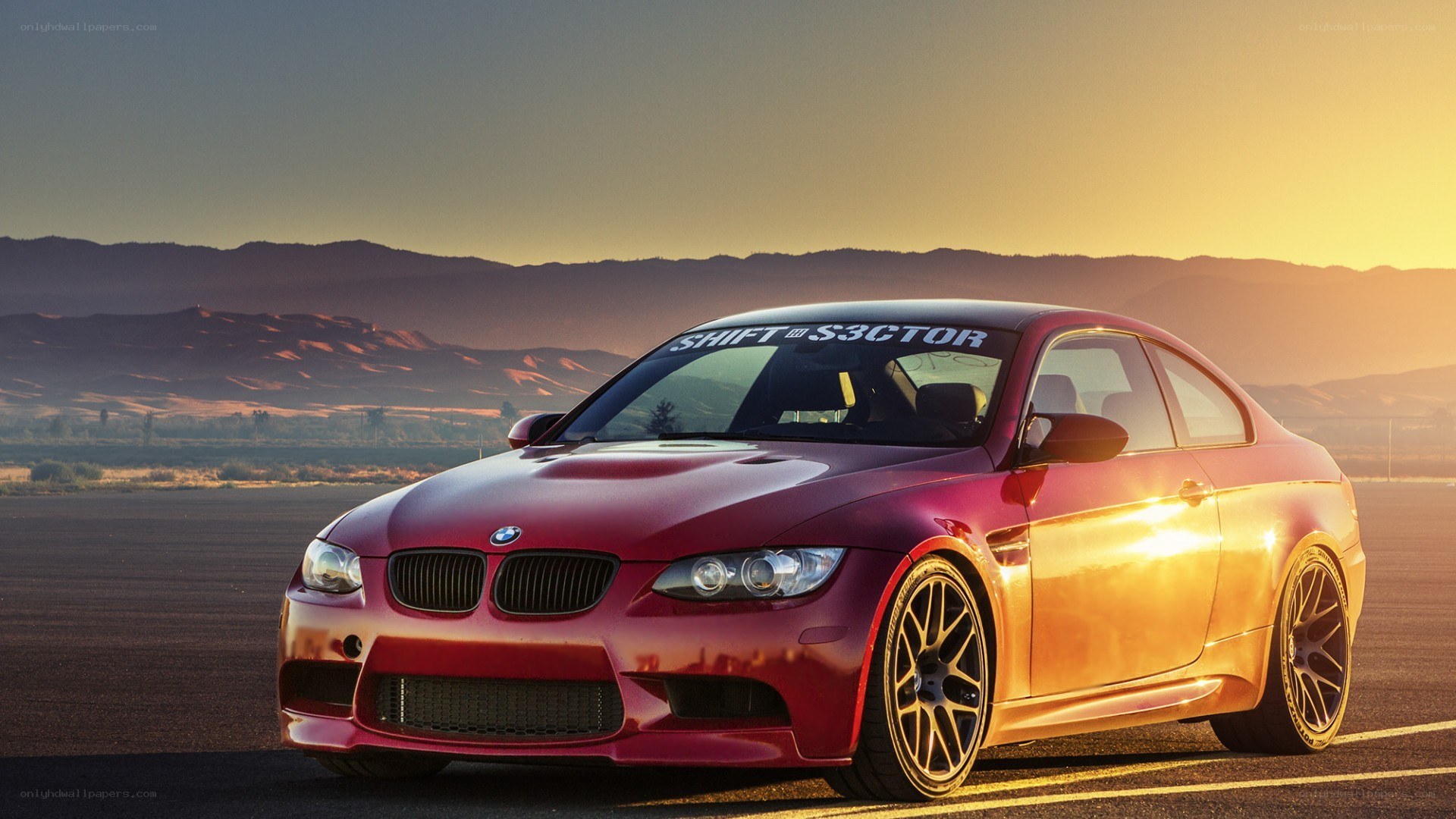 Red BMW M3 at sunset