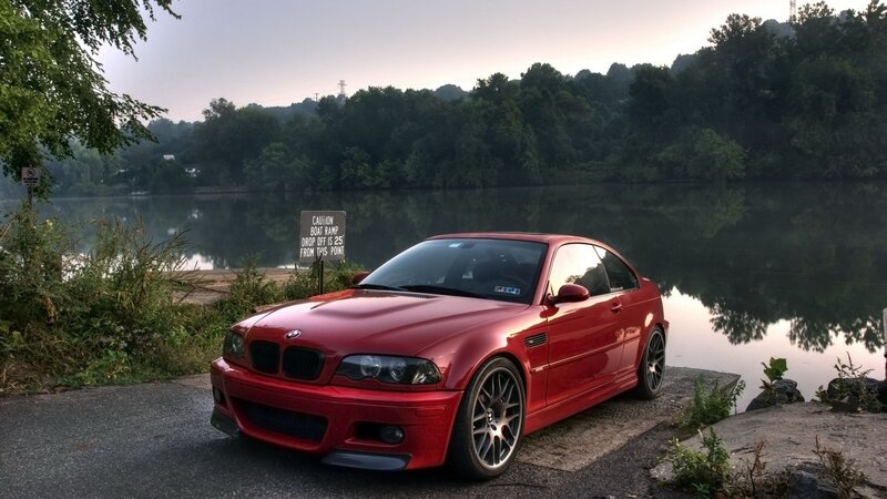 Red BMW M3 by a lake
