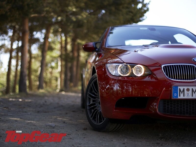 Red BMW M3 in forest