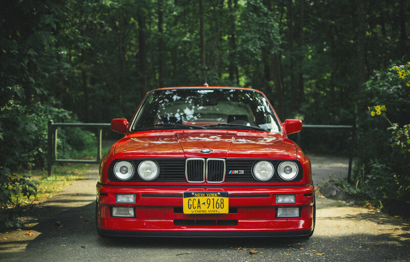 Red BMW M3 in forest