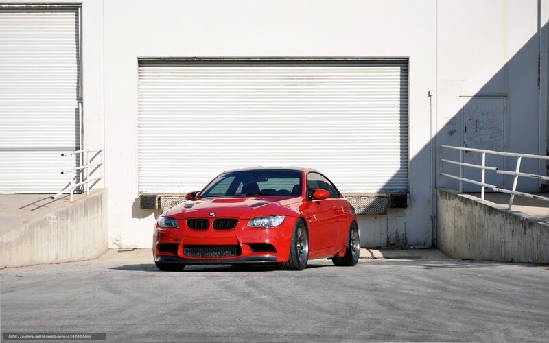 Red BMW M3 in front of garage