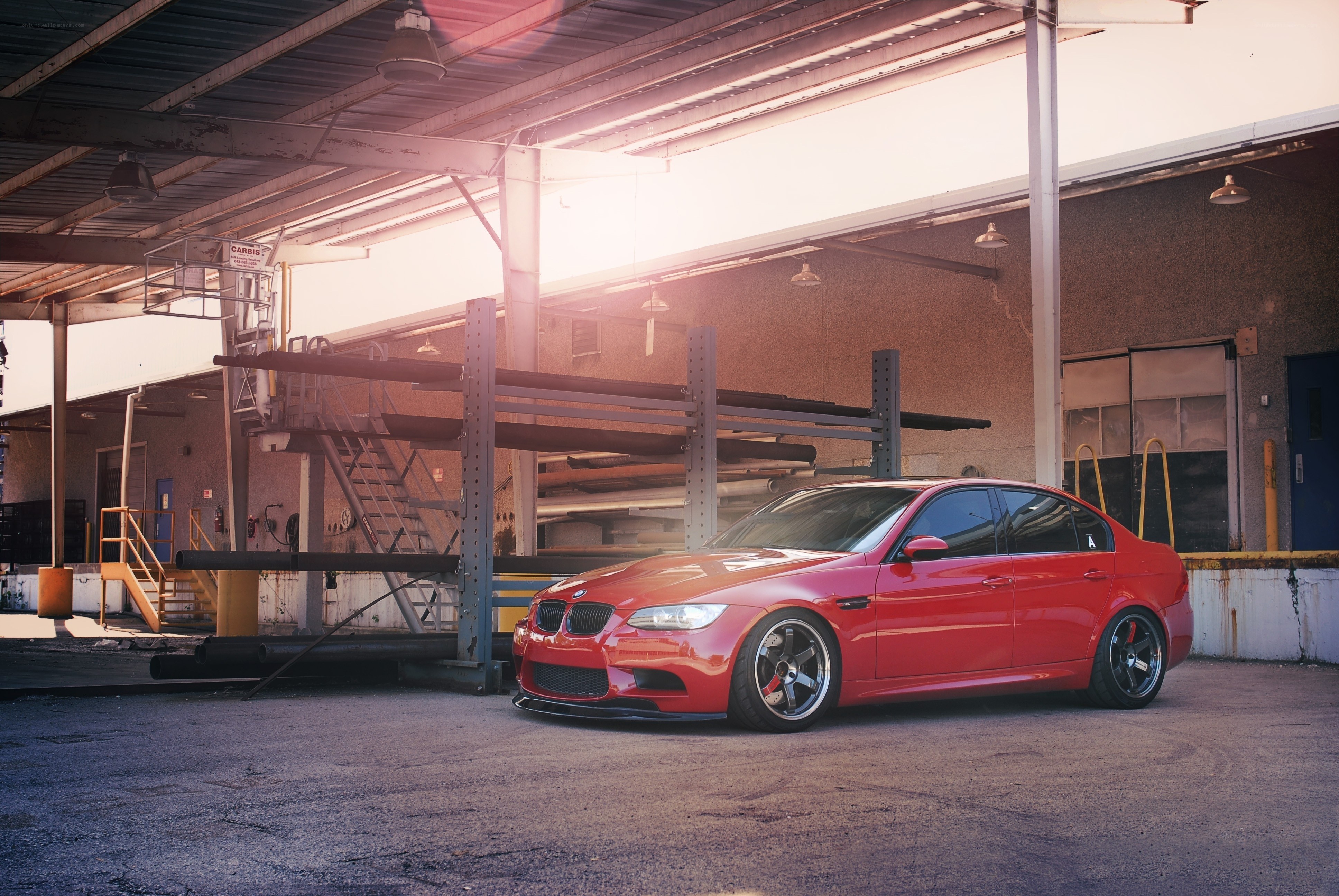 Red BMW M3 in industrial setting