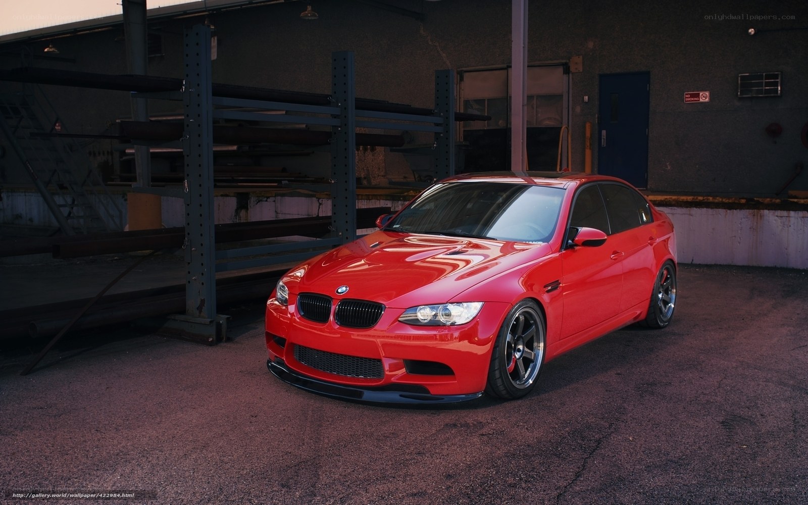 Red BMW M3 in industrial setting