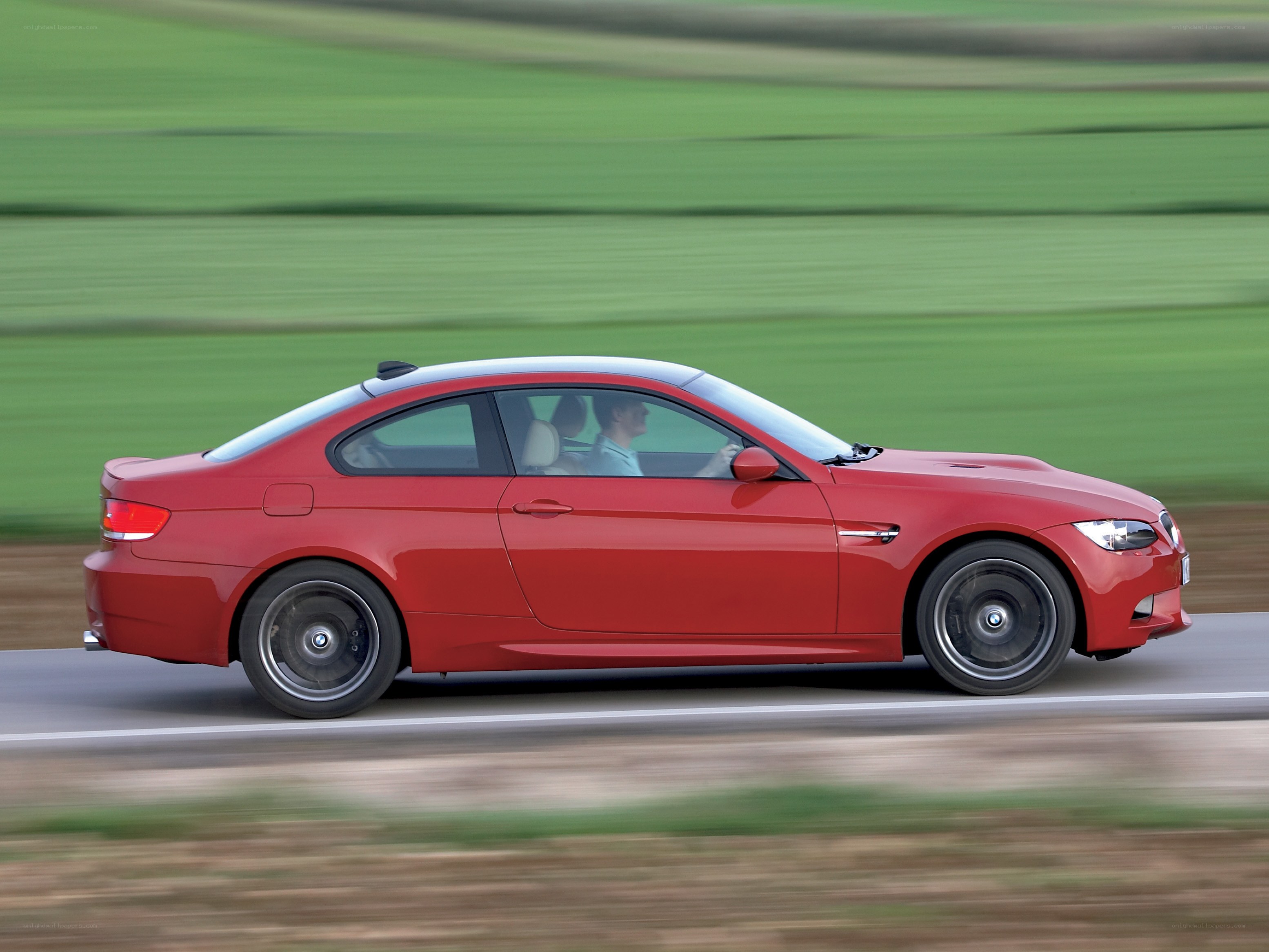 Red BMW M3 in motion