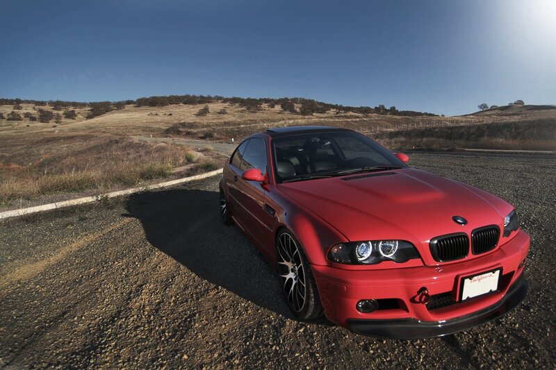 Red BMW M3 on a gravel road