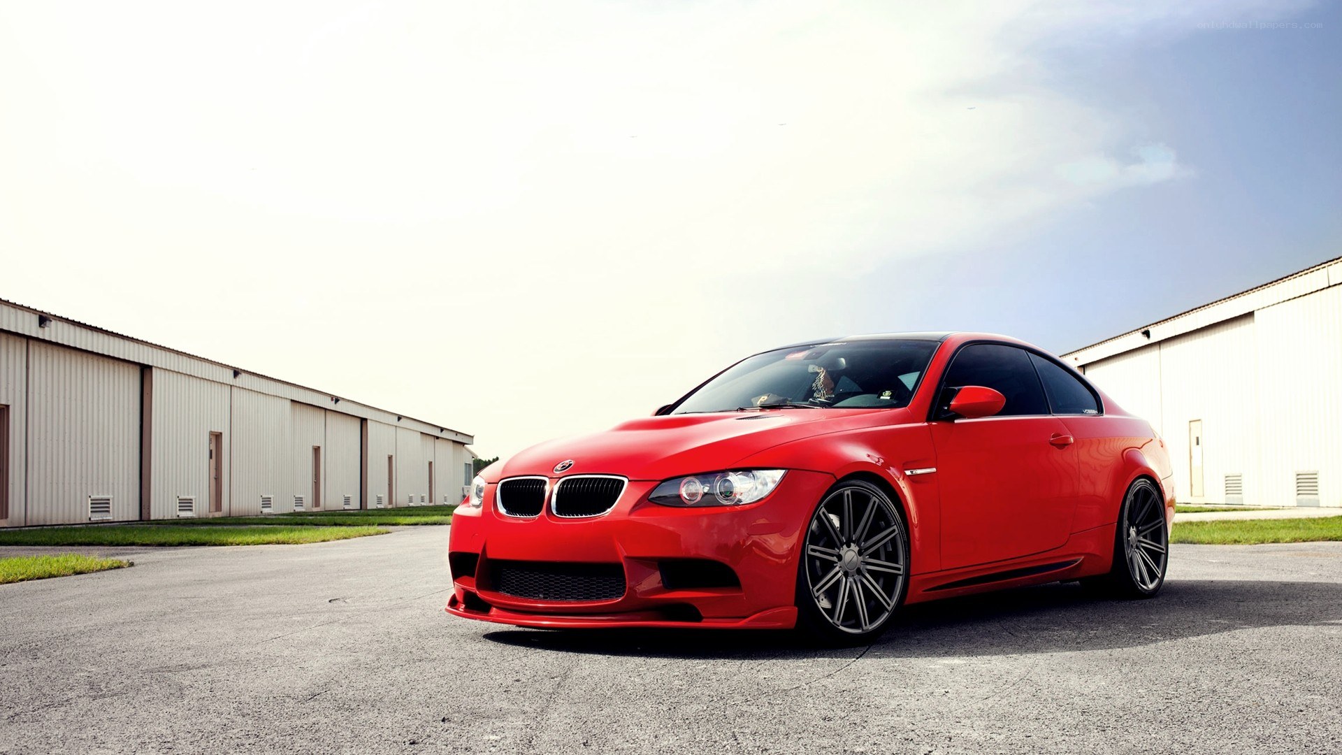 Red BMW M3 on a paved lot