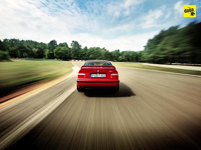 Red BMW M3 on a racetrack