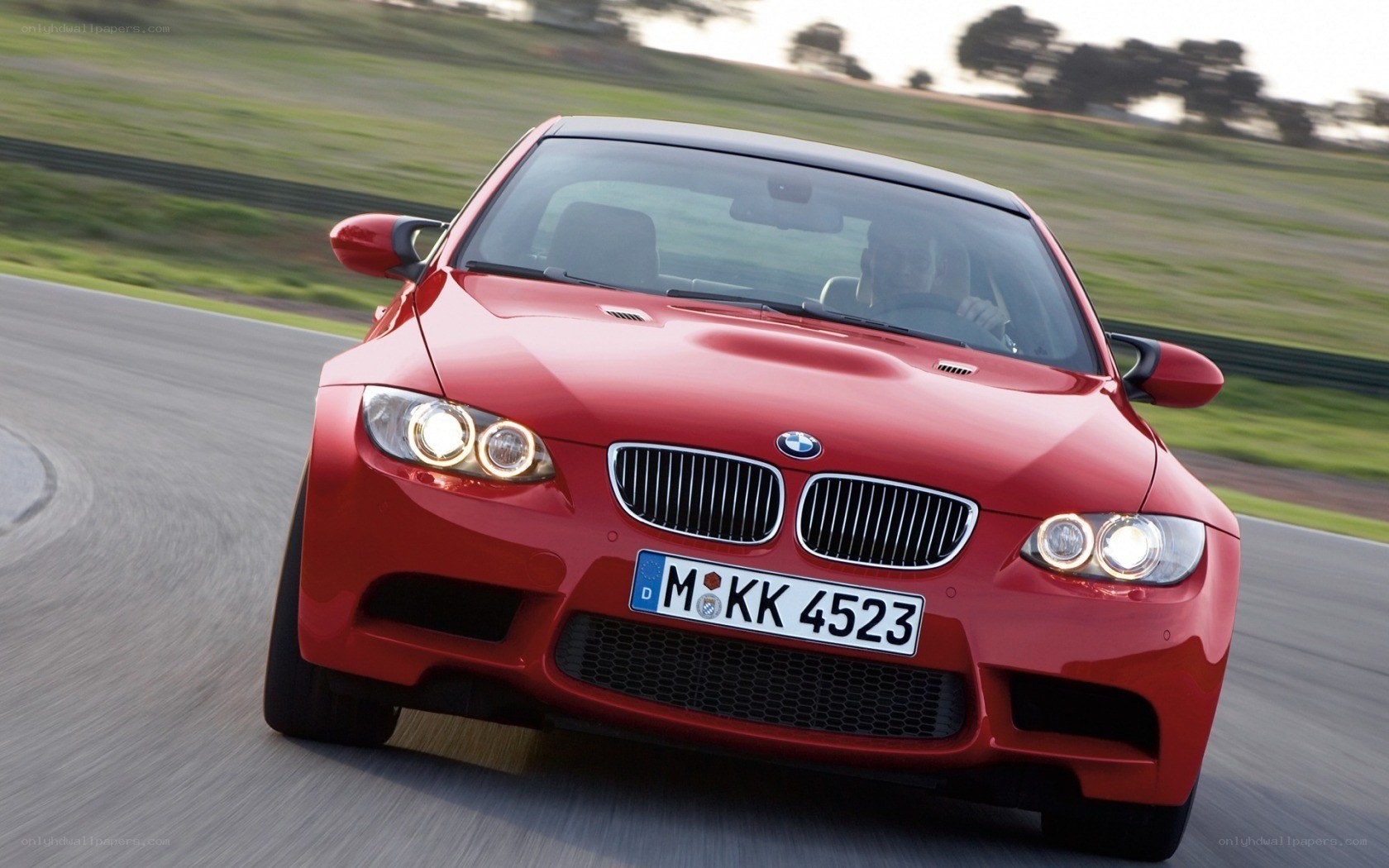 Red BMW M3 on a racetrack