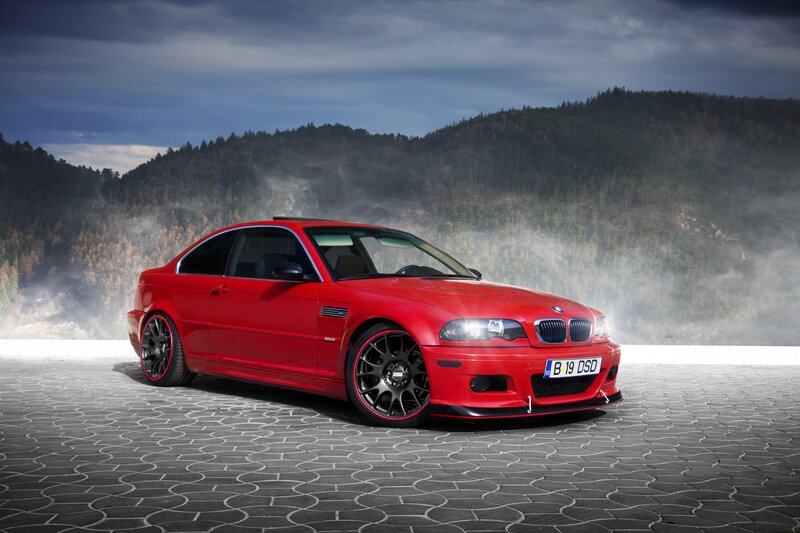 Red BMW M3 on a scenic road
