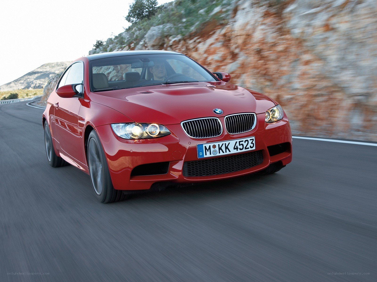 Red BMW M3 on a winding road