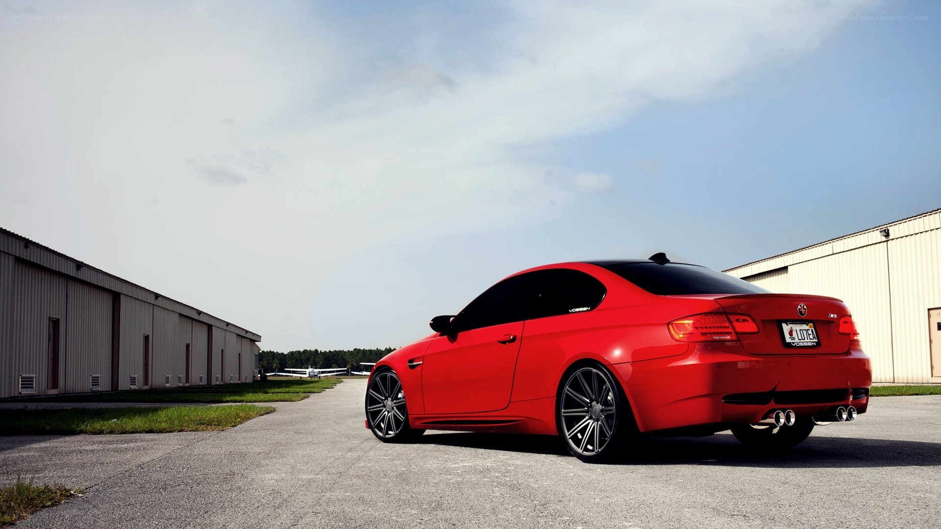 red bmw m3 on airfield