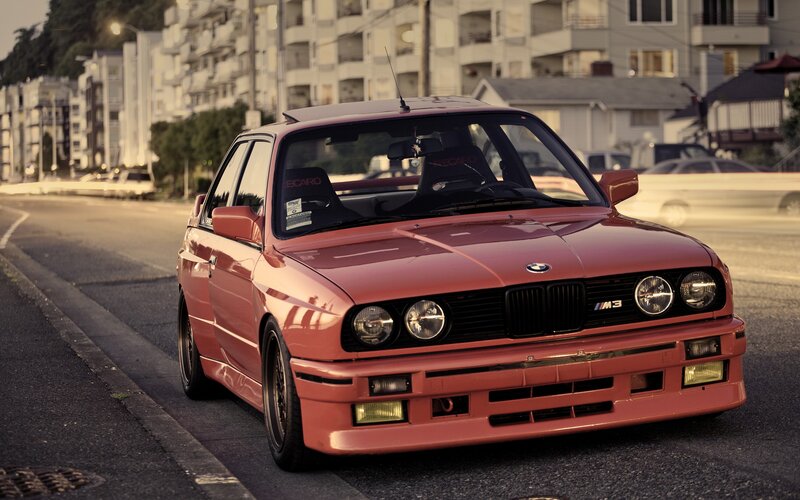 Red BMW M3 on city street