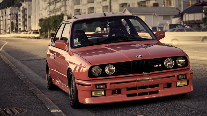 red bmw m3 on city street