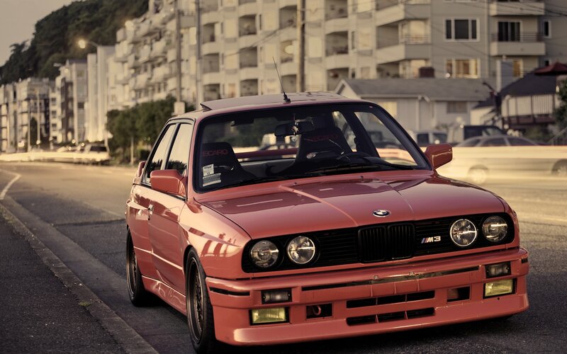 Red BMW M3 on city street