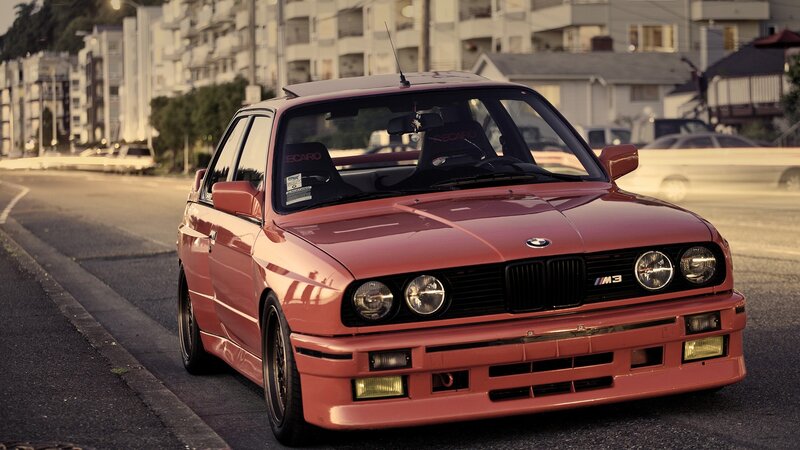 red bmw m3 on city street