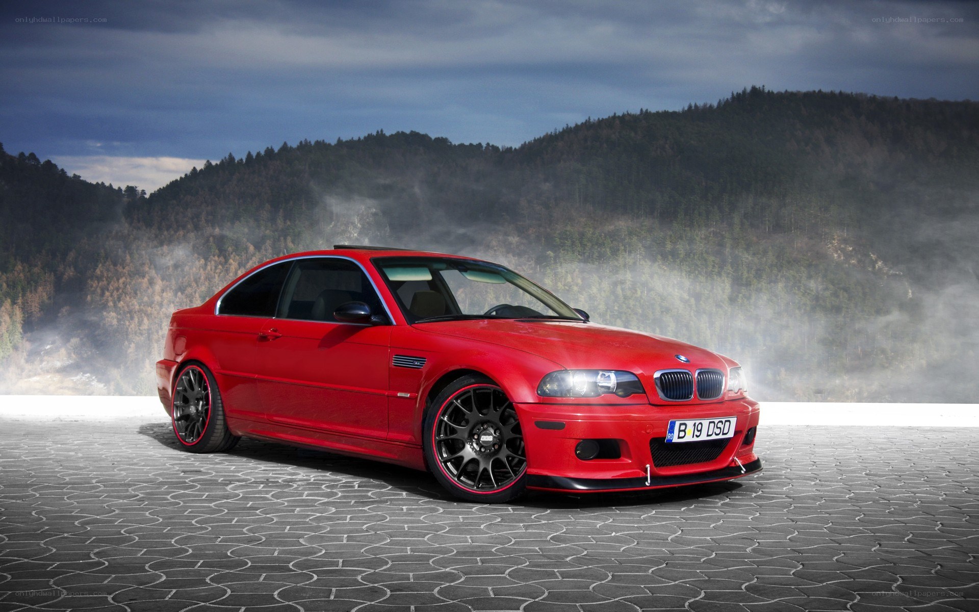Red BMW M3 on cobblestones