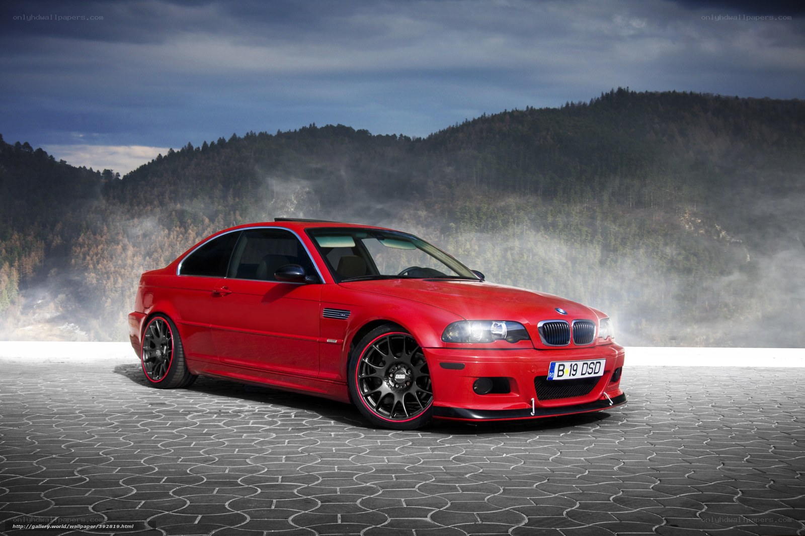 Red BMW M3 on cobblestones