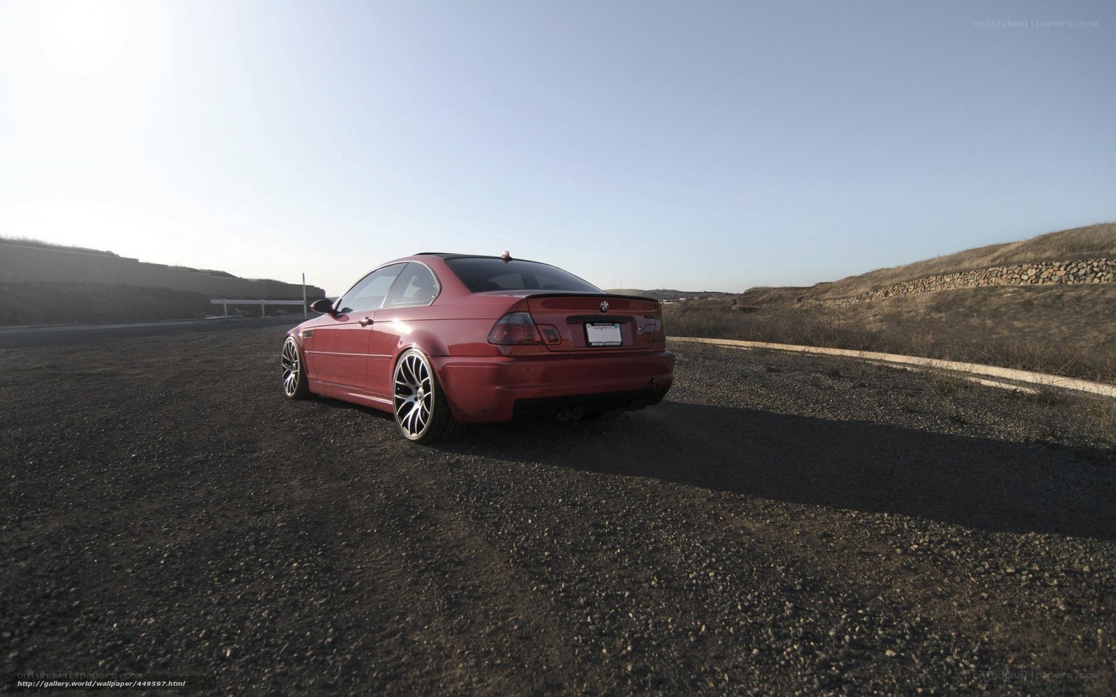 red bmw m3 on gravel