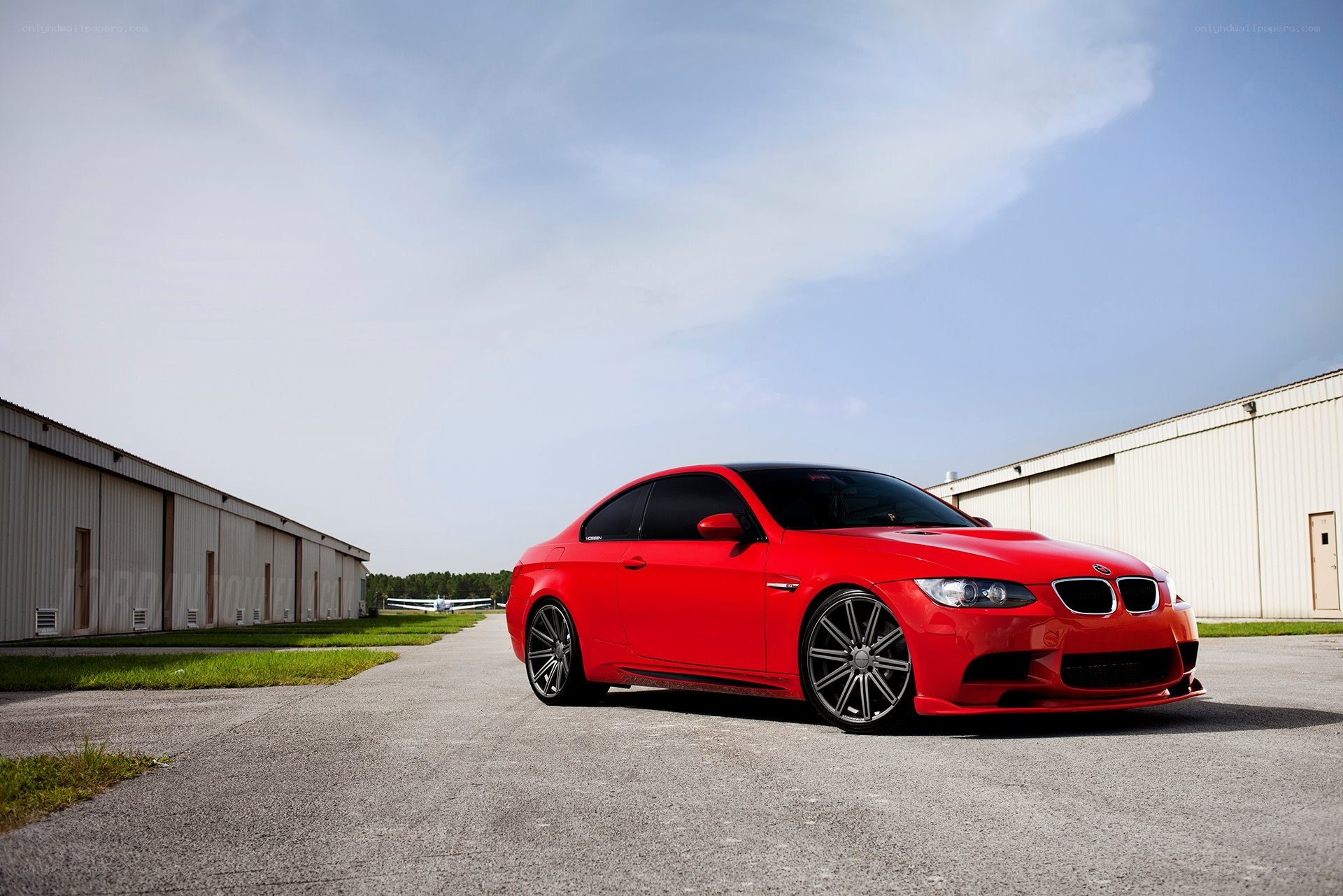 Red BMW M3 on tarmac