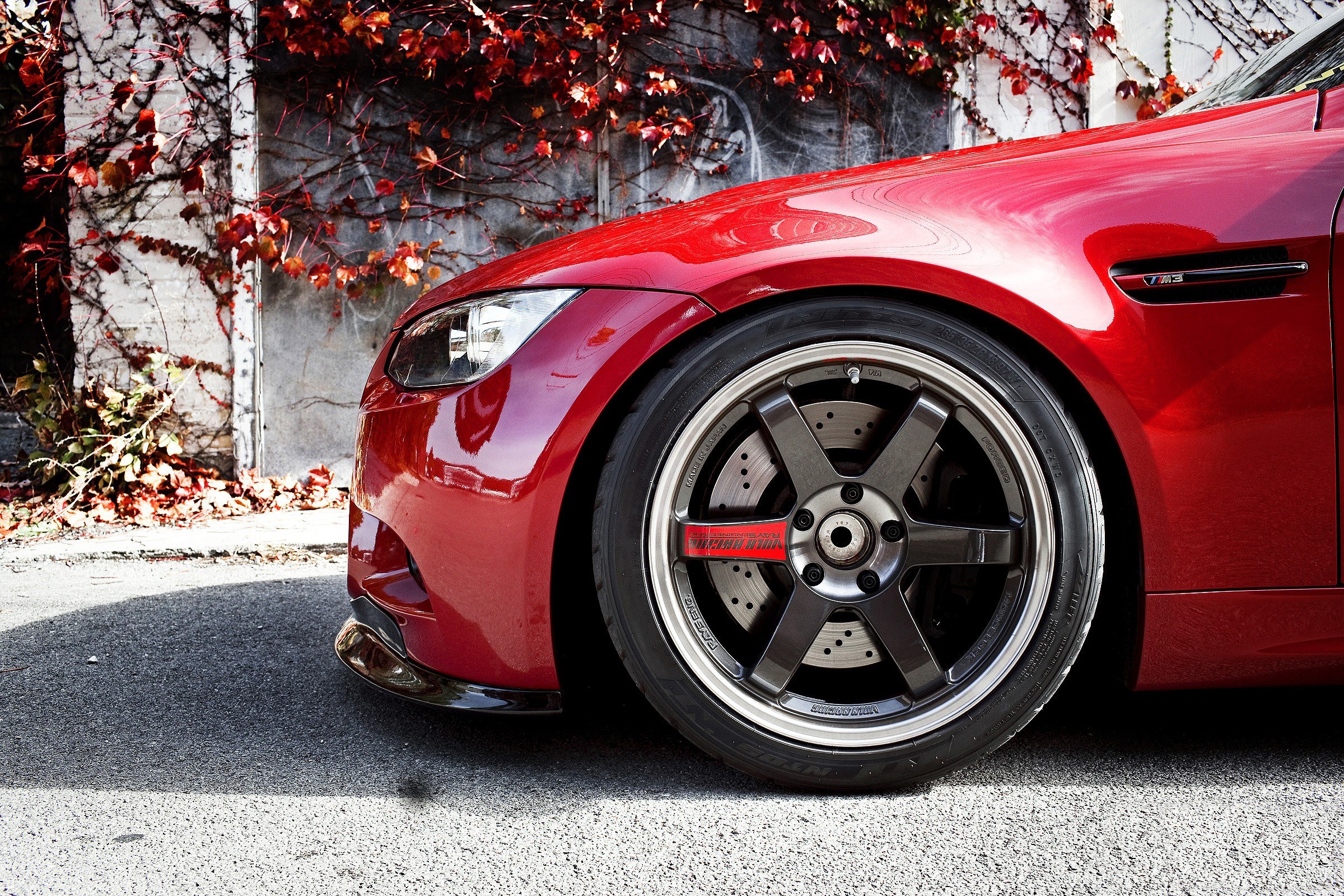 Red BMW M3 with custom wheels