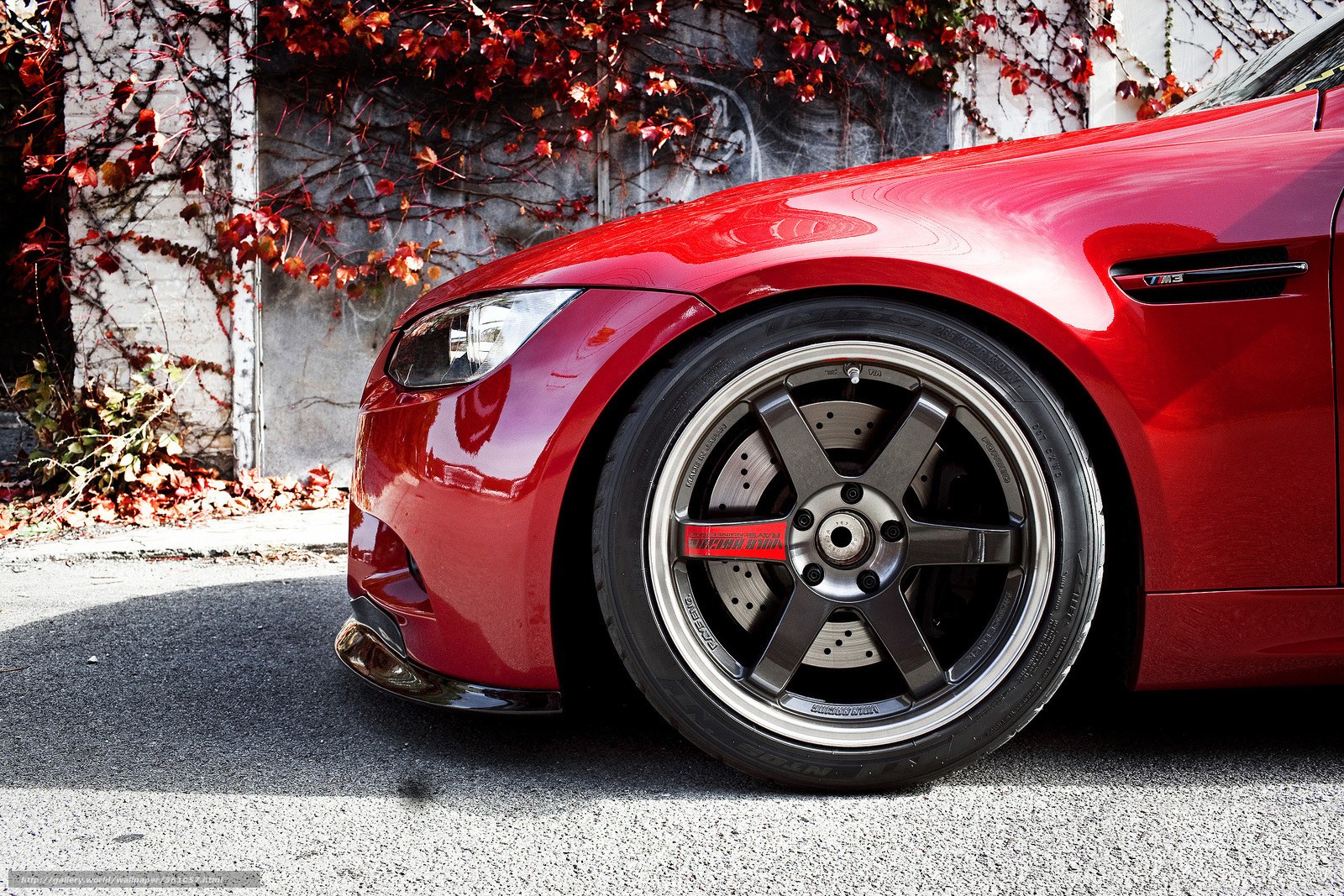 Red BMW M3 with custom wheels