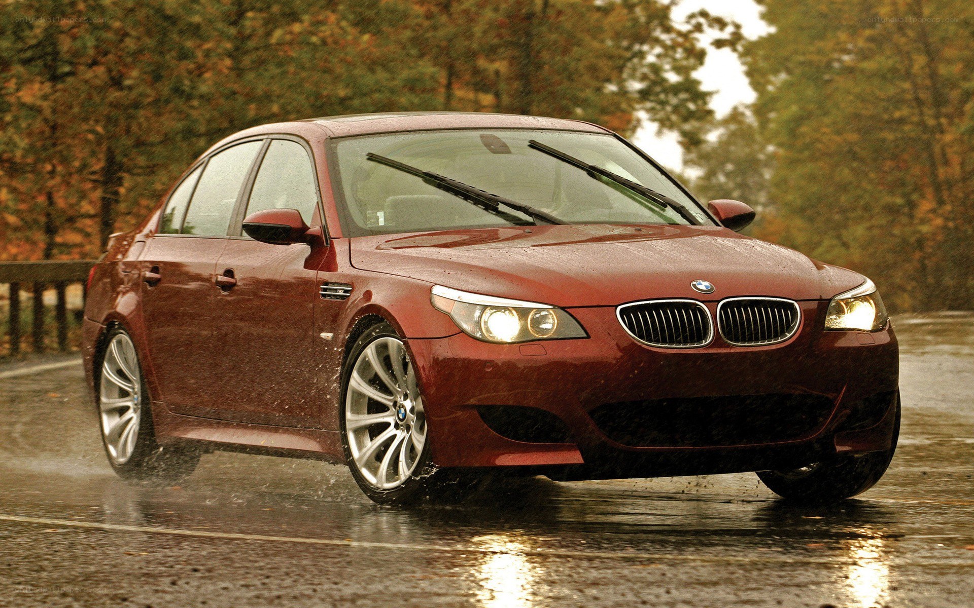 red bmw m5 driving in rain