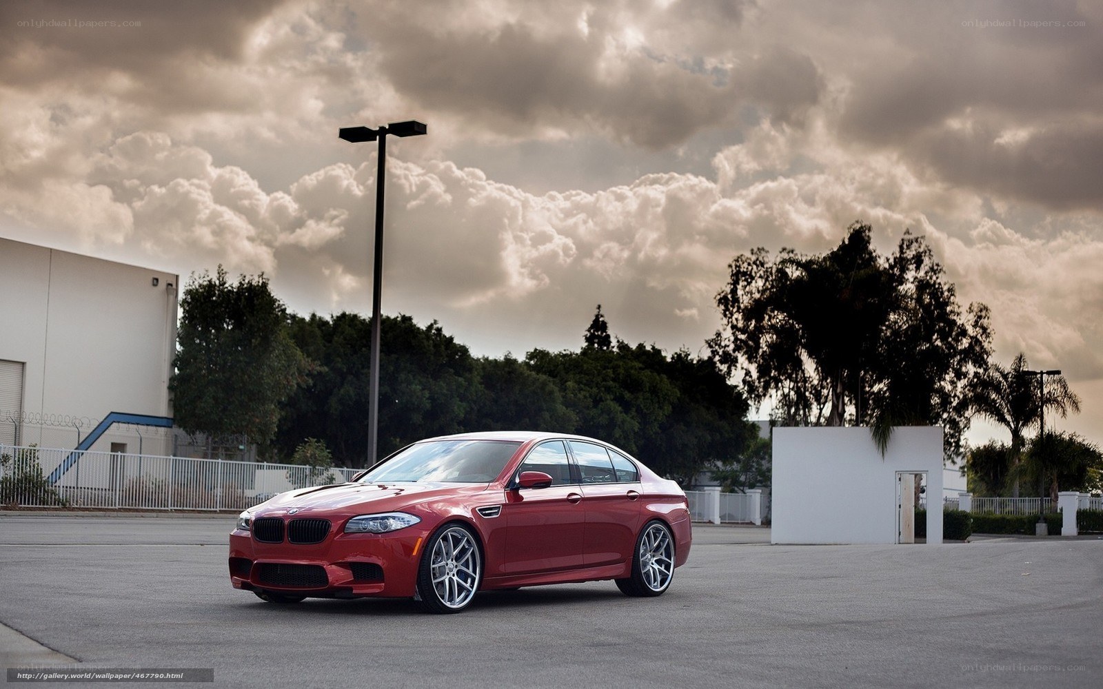 Red BMW M5 on a cloudy day