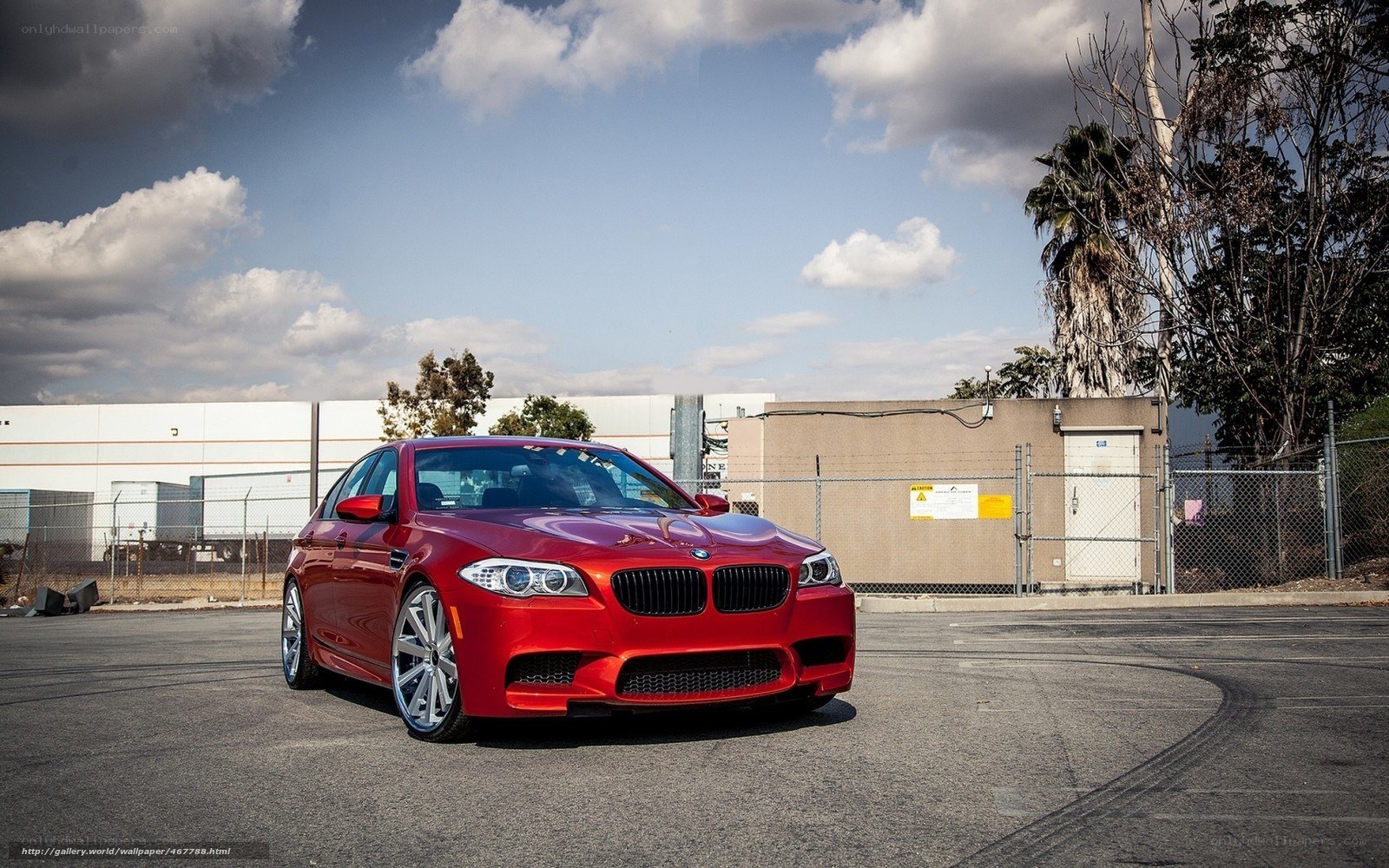 Red BMW M5 parked in lot