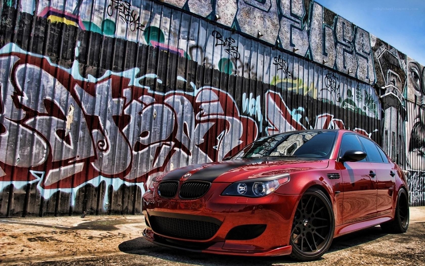 red bmw m5 with graffiti wall