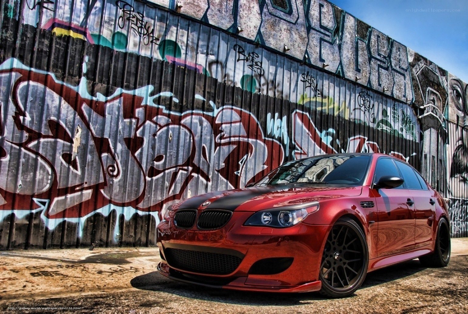 Red BMW M5 with graffiti wall