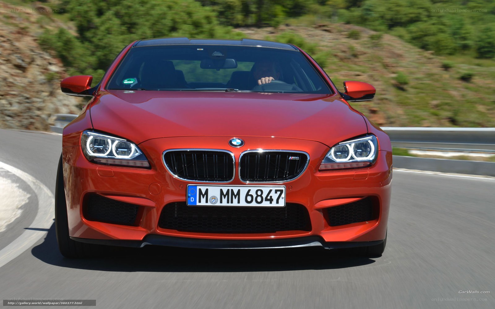 red bmw m6 driving on road