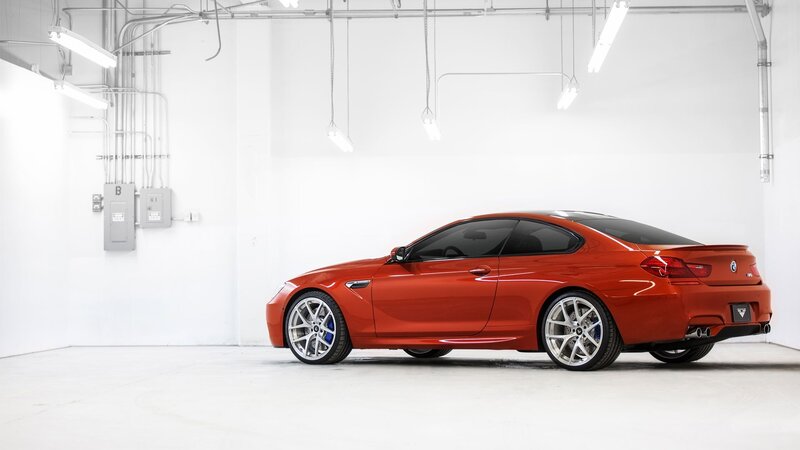 Red BMW M6 in a white garage