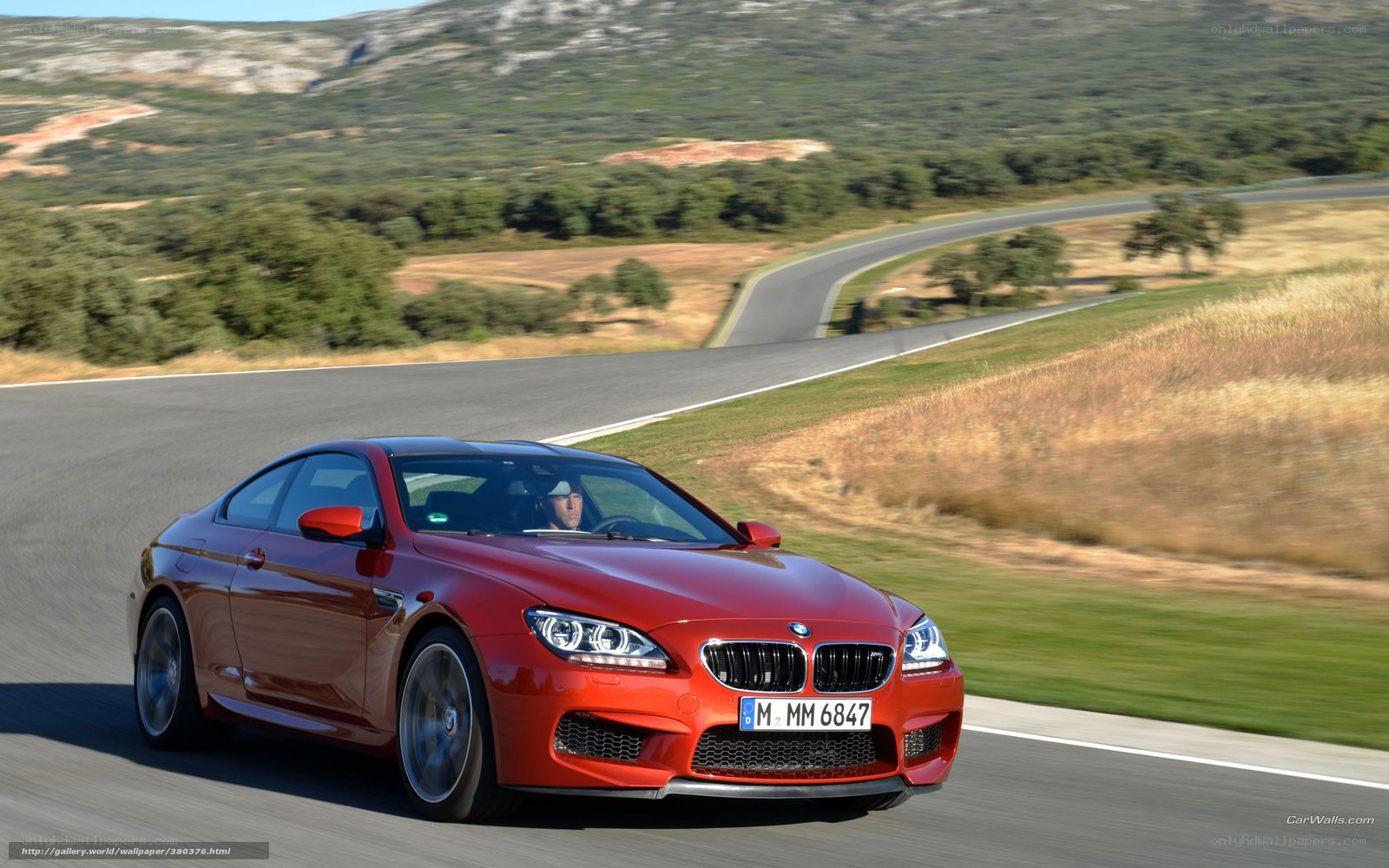 Red BMW M6 on a winding road
