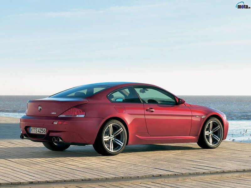 Red BMW M6 on a wooden pier