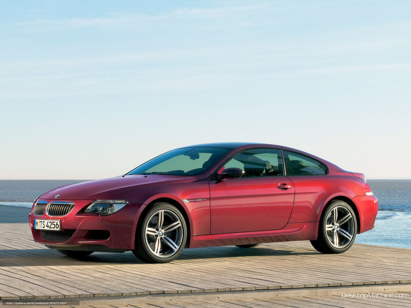 Red BMW M6 on a wooden pier