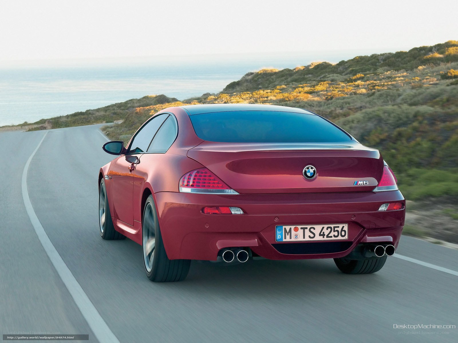 Red BMW M6 on coastal road