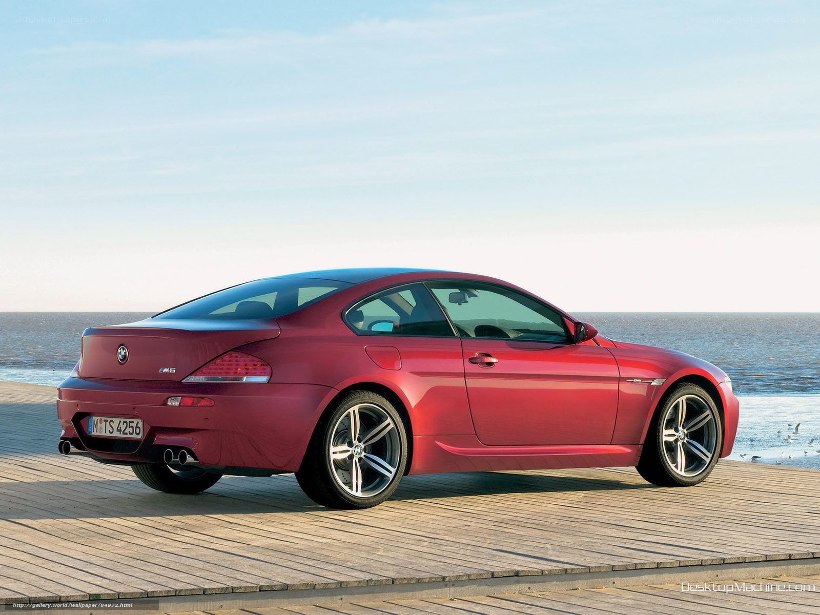Red BMW M6 on wooden pier