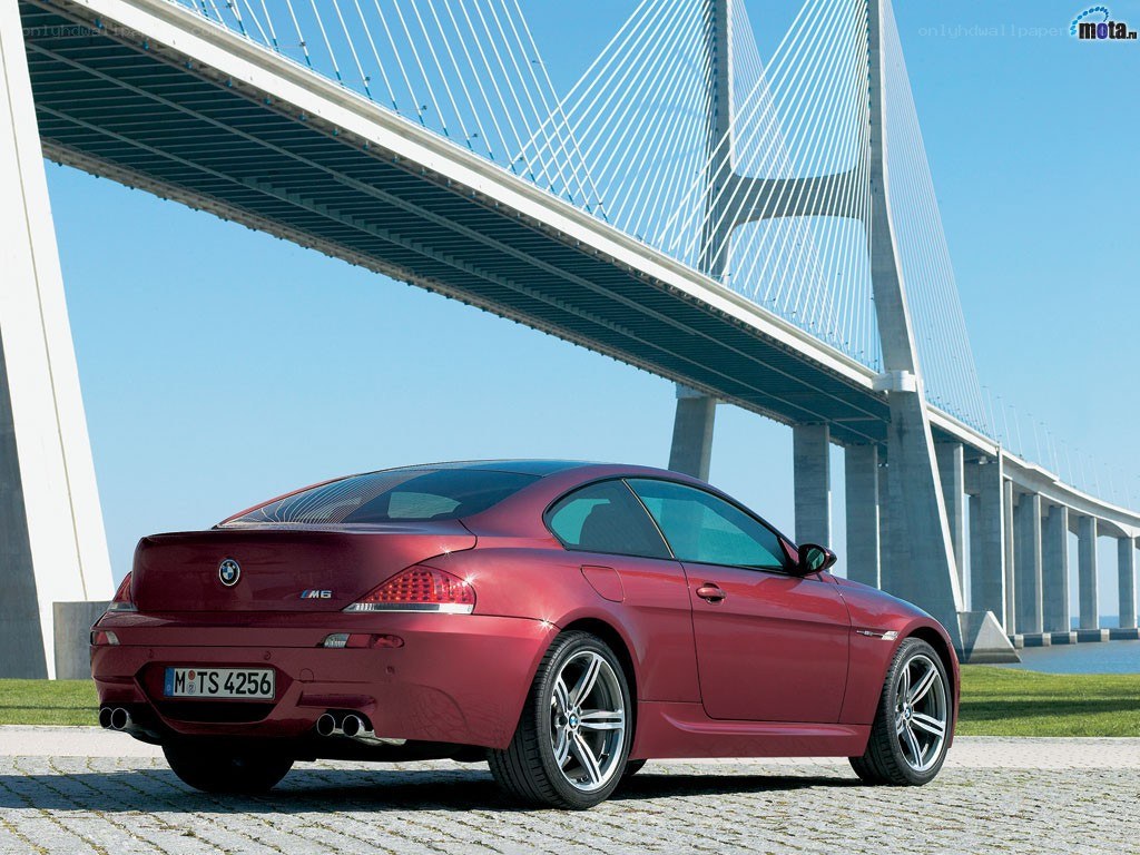 Red BMW M6 under a bridge