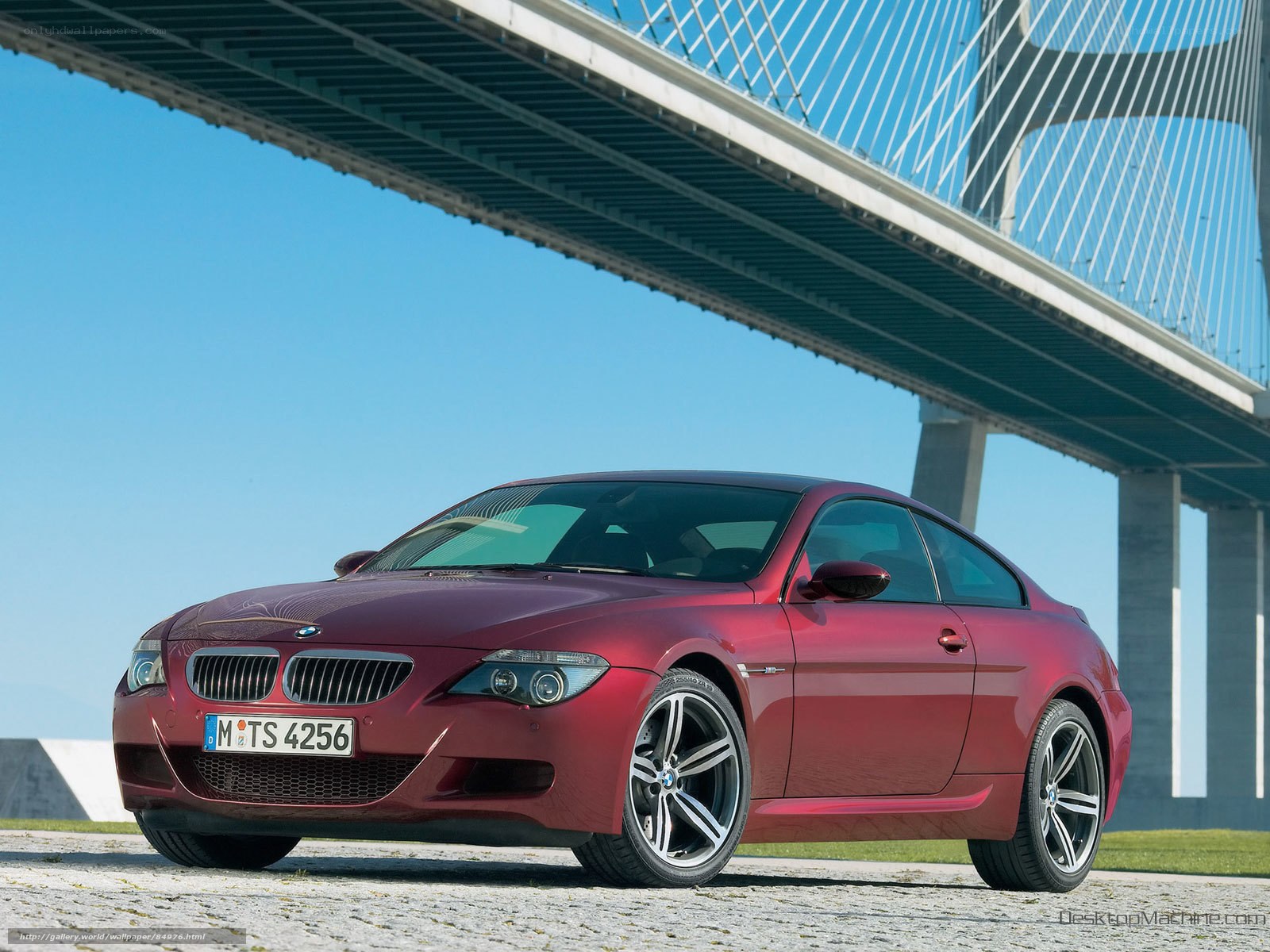 Red BMW M6 under a bridge