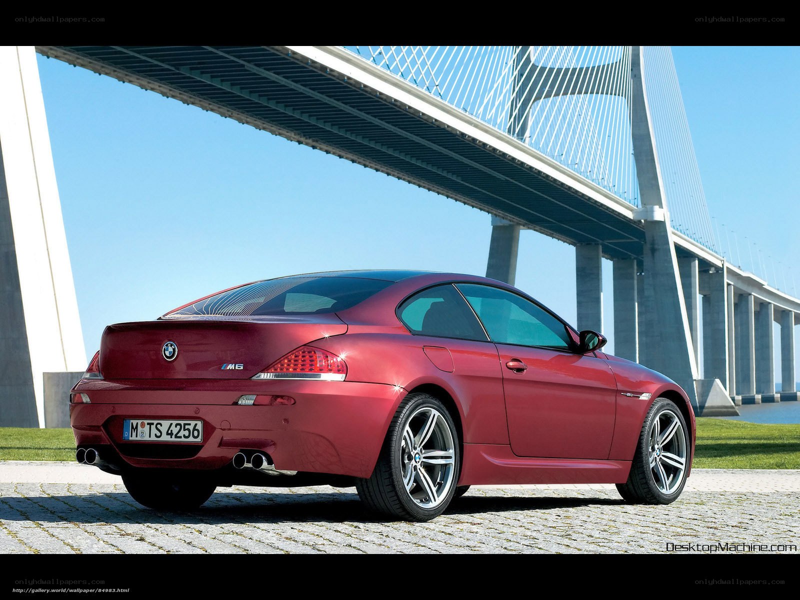 Red BMW M6 under bridge