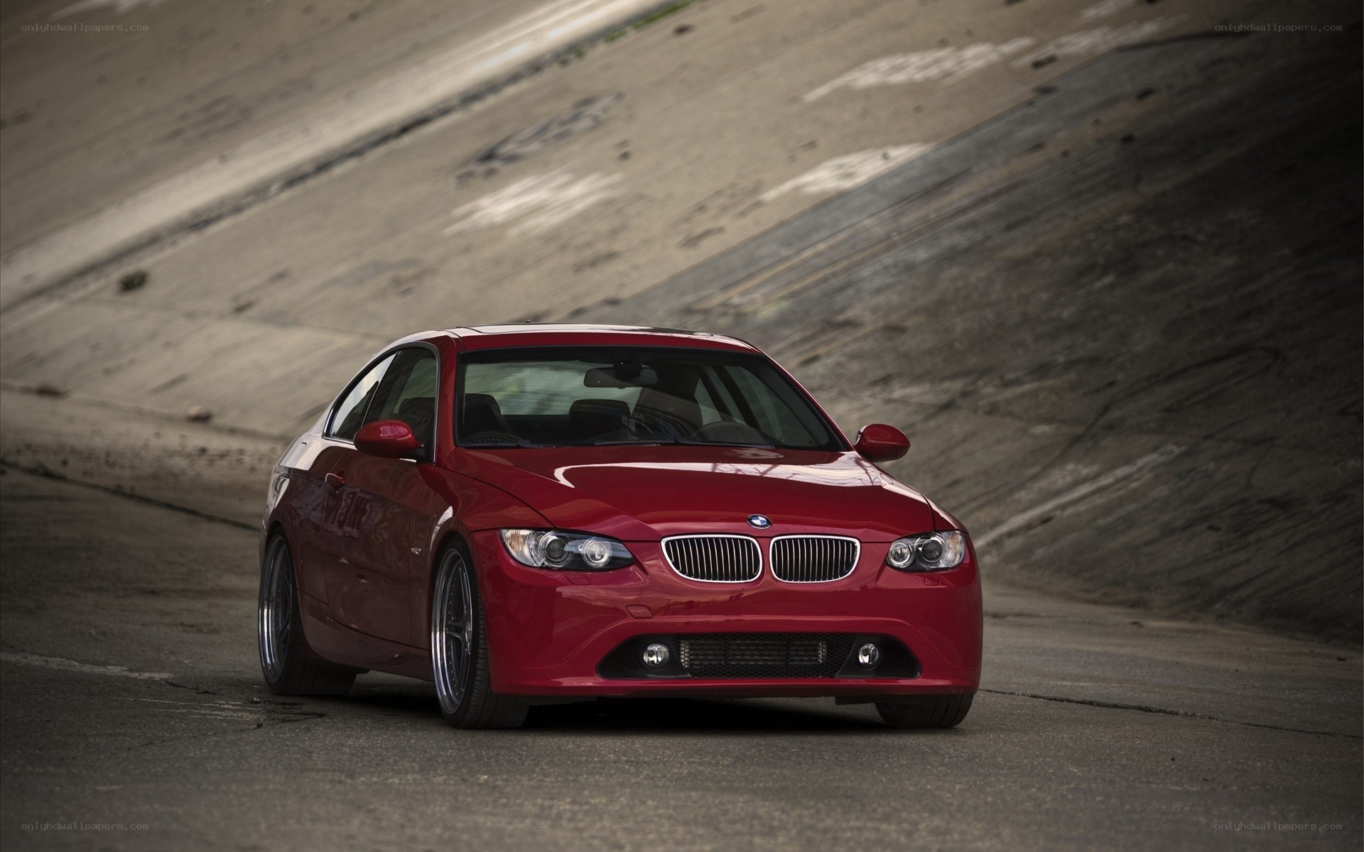 Red BMW on a concrete ramp